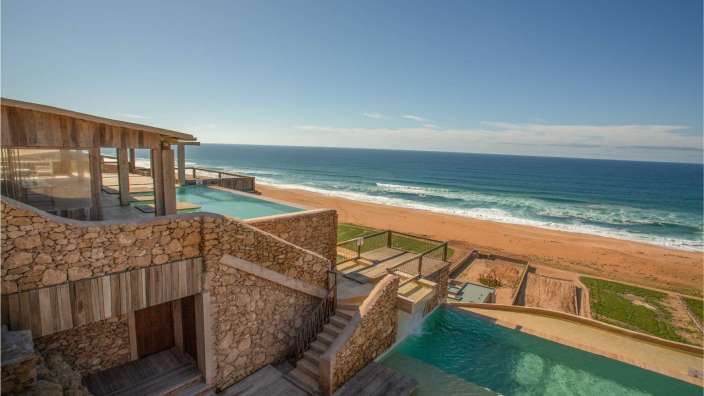 Ein Haus mit einem Pool und Blick auf den Ozean