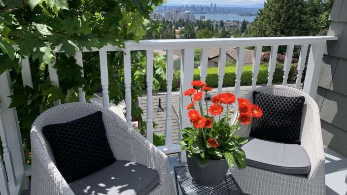 Ein Balkon mit zwei Stühlen und einem Blumentopf
