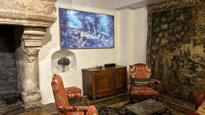 Ein Wohnzimmer mit Möbeln und einem Gemälde an der Wand