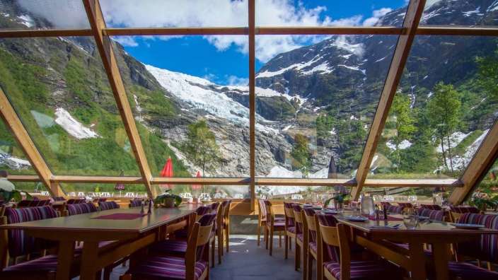 Tische und Stühle in einem Restaurant mit Blick auf die Berge