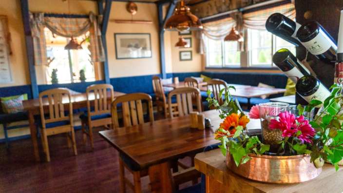 Eine Reihe von Weinflaschen hängt an einem Weinregal in einem Restaurant