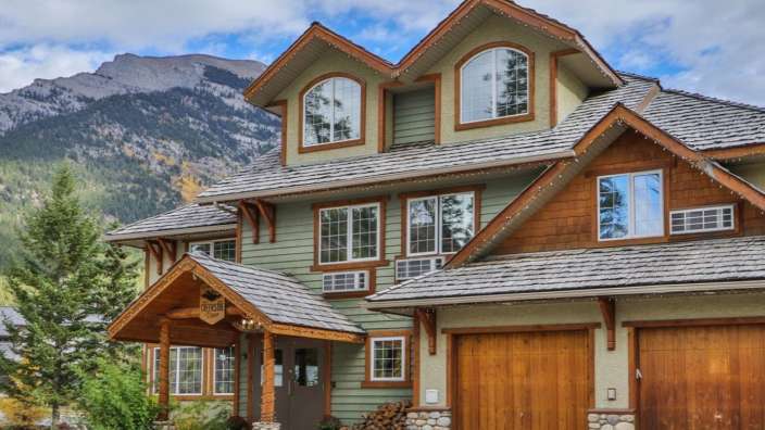 Ein großes Haus mit vielen Fenstern und einer Garage