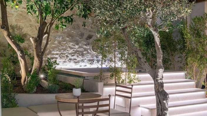 Ein Tisch und ein Stuhl in einem Garten neben einer Treppe