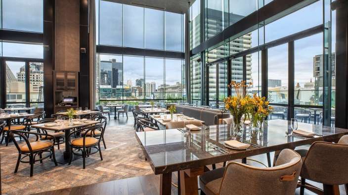 Ein Restaurant mit vielen Tischen und Stühlen und einem großen Fenster