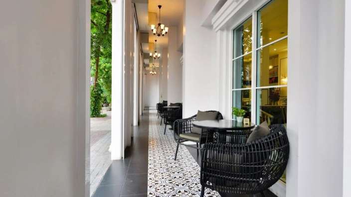 Eine lange Reihe von Tisch und Stühlen auf einem Balkon