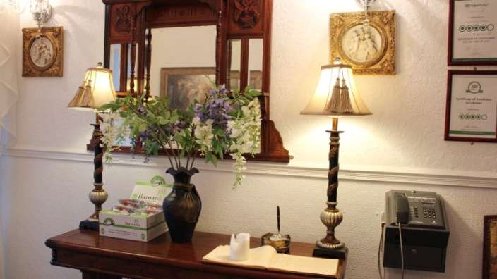 Ein Tisch mit zwei Lampen und einer Vase mit Blumen darauf