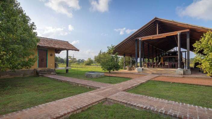 Ein kleines Haus mit einem großen Gebäude dahinter