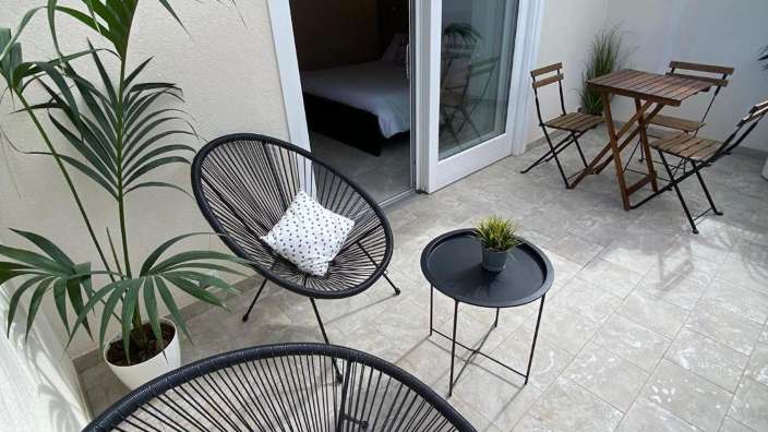 Ein kleiner Balkon mit zwei Stühlen und einem Tisch