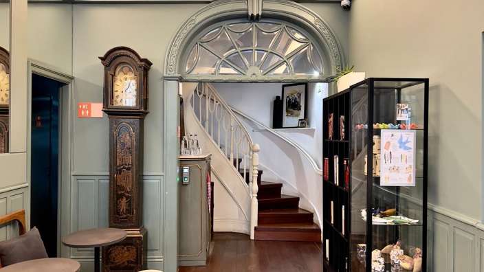 Ein Flur mit einer großen Uhr und einer Treppe