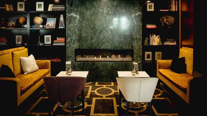 Ein Wohnzimmer mit Couch und Stühlen und einem Kamin