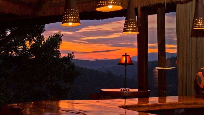 Ein Tisch mit einer Lampe darauf und ein Sonnenuntergang im Hintergrund