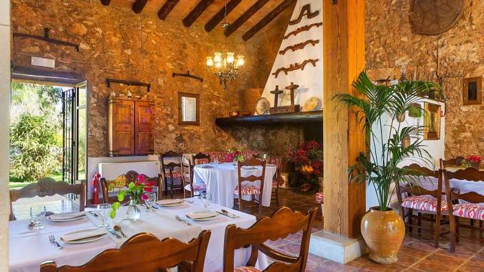 Ein Speisesaal mit Tischen und Stühlen und einem Kamin