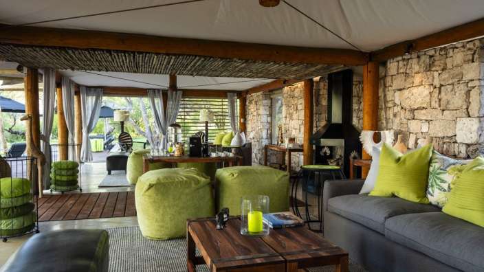 Ein Wohnzimmer mit einem grauen Couch und grünen Kissen