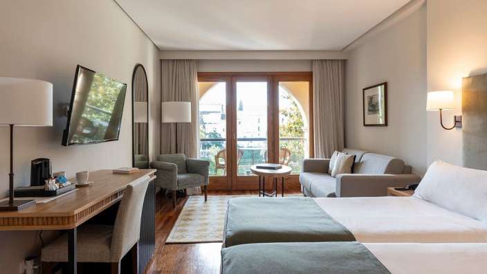 Ein Hotelzimmer mit zwei Betten und einem Fernseher