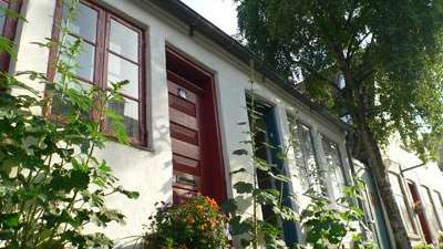 Eine Reihe von Häusern mit roten Türen und Fenstern