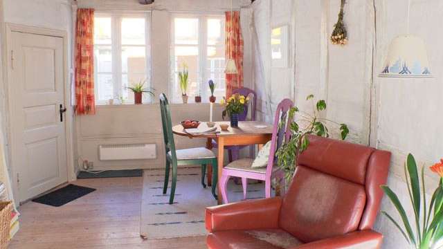 Ein Wohnzimmer mit einem roten Stuhl und einem Tisch