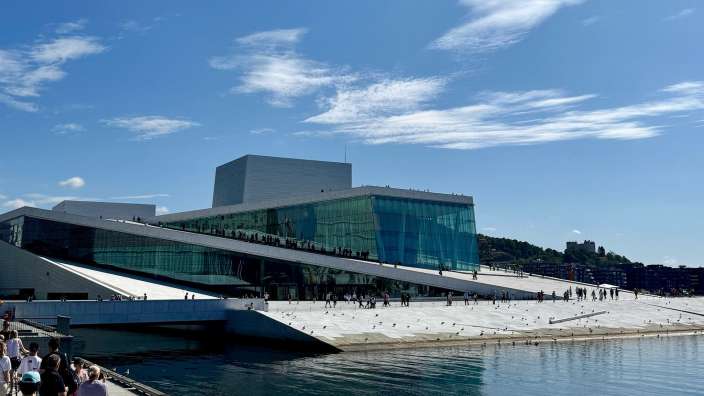 Eine Gruppe von Menschen steht vor einem großen Gebäude