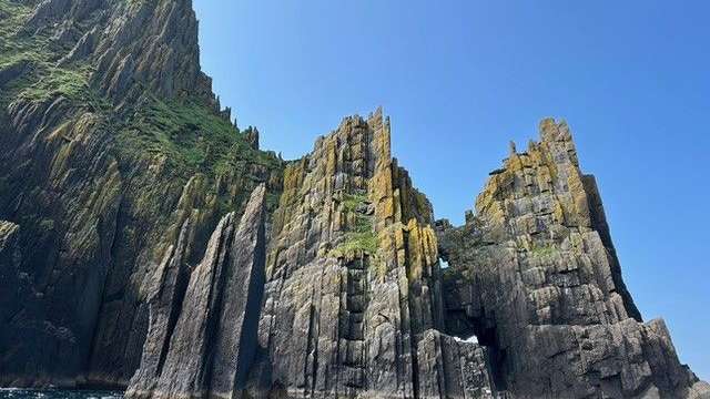 Eine Gruppe von Menschen in einem Boot in der Nähe einer Klippe